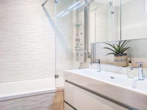 a bathroom with a sink and a shower at Apartment Allod Park Haus C 505 by Interhome in Davos