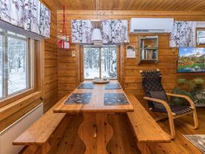 a dining room with a wooden table and chairs at Holiday Home Sallanrinne b by Interhome in Salla