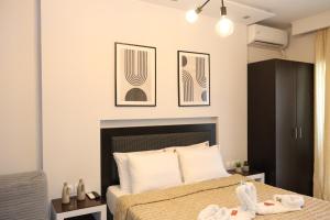 a bedroom with a bed with two towels on it at Ktima Papaoikonomou in Potos +57 photos