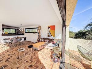 a living room with a patio with a table and chairs at Villa La Maison du Midi by Interhome in Saint-Aygulf