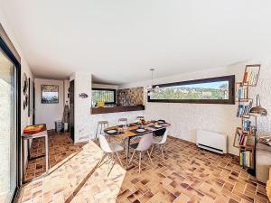 a kitchen and dining room with a table and chairs at Villa La Maison du Midi by Interhome in Saint-Aygulf