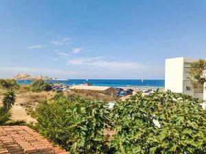a view of the beach from the balcony of a building at Holiday Home Posidonie by Interhome in LʼÎle-Rousse