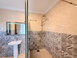 a bathroom with a shower and a sink at Star Wish Business Hotel in Lagos +43 photos