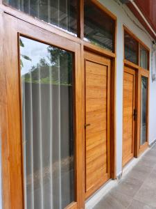 a pair of glass doors on a house at Cozzee AnD in Labuan Bajo