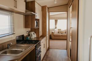 a kitchen with a sink and a stove top oven at Upper Cliff 4 in Easton