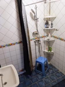 a bathroom with a sink and a blue stool at Herrgårdsvillan in Tjurkö +7 photos
