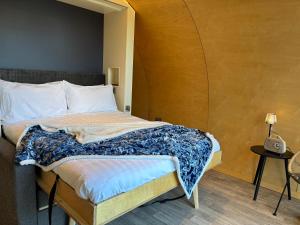 a small bedroom with a bed with aigiligiligiligil at Glenarm Castle Ocean View Pods in Glenarm