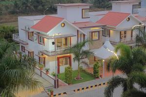 an overhead view of a house with palm trees at Heritage Shelters Resort in Mysore
