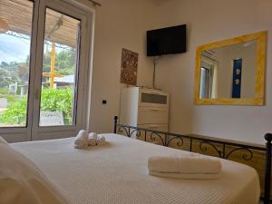 a bedroom with a bed with two towels on it at Bedda Mia - Lipari in Lipari +12 photos