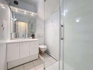 a white bathroom with a shower and a toilet at Studio Le Drakkar by Interhome in Trouville-sur-Mer