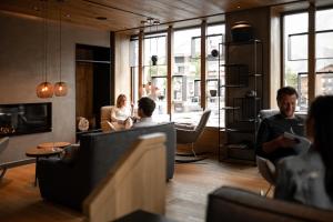 a group of people sitting in a living room at Berghotel Kleiner Biber in Warth am Arlberg