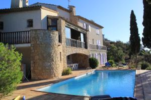 a house with a swimming pool in front of a house at Villa Lucienne in Les Issambres