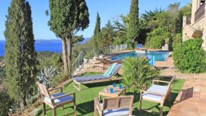 a patio with chairs and a swimming pool at Villa Lucienne in Les Issambres