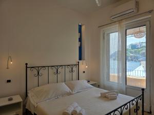 a bedroom with a bed with two towels on it at Bedda Mia - Lipari in Lipari