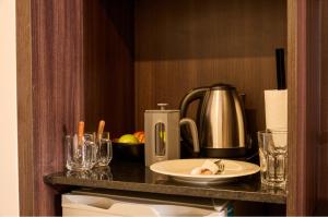 a table with a plate of food and a kettle at Nuit Hotel in Mar del Plata +52 photos