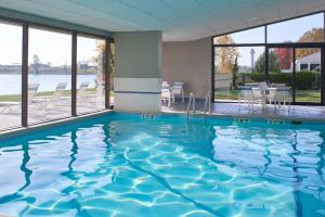 a swimming pool with a view of the water at Kansas City Airport Marriott in Kansas City