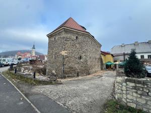 an old stone building on the side of a street at Penzion Bašta in Bílina