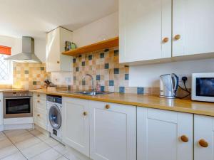 a kitchen with white cabinets and a sink at 2 Bed in Ashbourne oc-82579 in Longford +10 photos