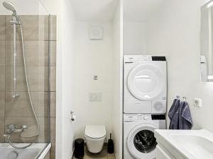 a bathroom with a washing machine next to a shower at Apartment Seezauber by Interhome in Lembruch