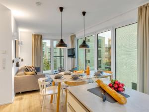 a kitchen and living room with a table and chairs at Apartment Seezauber by Interhome in Lembruch