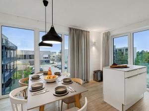 a kitchen and dining room with a table and chairs at Apartment Seezauber by Interhome in Lembruch +34 photos