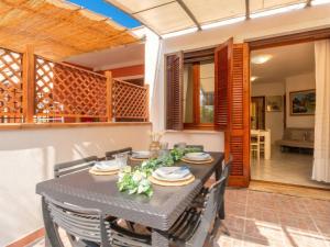 a dining room with a table and chairs at Apartment Rais 13 by Interhome in Stintino