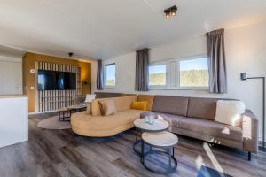 a living room with a couch and a table at Landal Winterberg in Winterberg