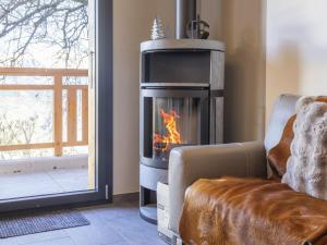a living room with a fireplace next to a couch at Chalet Byzance by Interhome in Nendaz