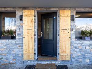 a front door of a house with wooden shutters at Chalet Byzance by Interhome in Nendaz