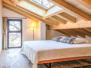 a bedroom with a large bed with a wooden ceiling at Chalet Byzance by Interhome in Nendaz