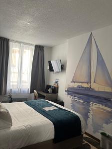 a bedroom with a bed and a painting of a sailboat on the wall at Ambassadeur Hotel - Cherbourg Port de Plaisance in Cherbourg en Cotentin