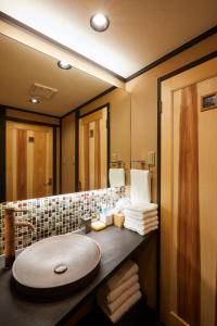 a bathroom with a sink and a mirror at Miro Hachijo Uchidacho Tei in Kyoto