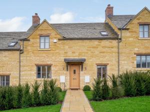 a large brick house with a brown door at 2 Bed in Chipping Campden oc-78128 in Chipping Campden