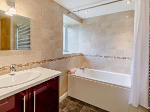 a bathroom with a white tub and a sink at 3 Bed in Eyam oc-pk835 in Eyam +5 photos