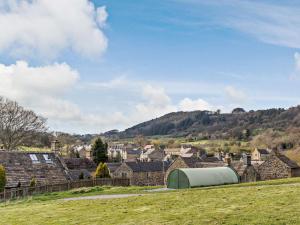 a view of a village with a hill in the background at 3 Bed in Eyam oc-pk835 in Eyam