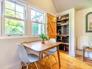 a dining room with a wooden table and chairs at Forest View Barn in Balcombe