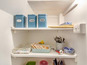a shelf with a bunch of items on it at Forest View Barn in Balcombe +9 photos