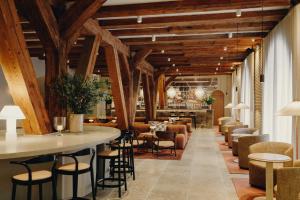 a bar in a restaurant with wooden ceilings at Admiral Hotel Copenhagen in Copenhagen