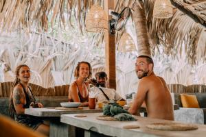 a group of people sitting at a table in a restaurant at Fins Arugambay in Arugam Bay