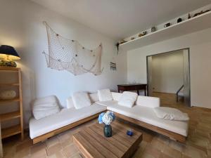 a living room with a white couch and a table at Bedda Mia - Lipari in Lipari