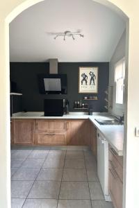 a kitchen with wooden cabinets and a counter top at Villa Tarabucetta by Interhome in Figari