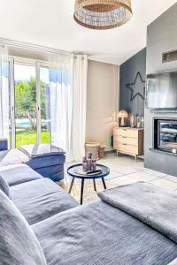 a living room with two beds and a fireplace at Villa Tarabucetta by Interhome in Figari