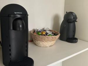 a espresso machine sitting on a counter next to a basket of keys at Villa Tarabucetta by Interhome in Figari
