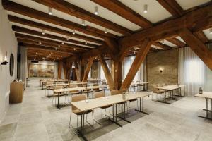 a dining room with tables and chairs and wooden beams at Admiral Hotel Copenhagen in Copenhagen +106 photos