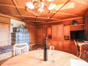a dining room with a table and two wine glasses at Chalet Schlitters by Interhome in Schlitters