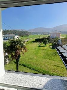 a view from the window of a house with a palm tree at Casa María 3 in Barcia