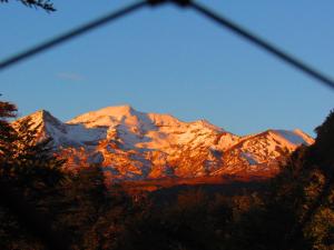 a view of a mountain with snow on it at Curahuapi Refugio de Montaña in Las Trancas
