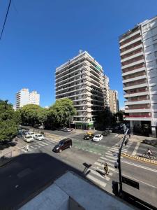 a city street with cars parked in a parking lot at Pin-up hostel in Rosario
