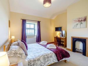a bedroom with a bed with a fireplace and a desk at 3 Bed in Consett oc-29403 in Lanchester