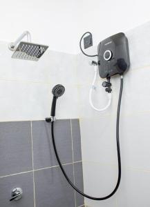 a shower with a camera in a bathroom at City Villa Dikwella in Dickwella